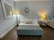 Cozy living area with a plush ottoman, sofa, and a decorative wall clock at 1600 Ocean Blvd. S # 204, Myrtle Beach, SC 29577