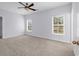 Bright bedroom featuring neutral carpet, a ceiling fan, and two windows at 1636 Stuart Square Circle, Myrtle Beach, SC 29577