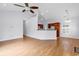 Bright living room with hardwood floors, high ceiling with fan, open to the kitchen area at 1636 Stuart Square Circle, Myrtle Beach, SC 29577