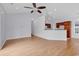 Bright living room with hardwood floors, high ceiling with fan, open to the kitchen area at 1636 Stuart Square Circle, Myrtle Beach, SC 29577
