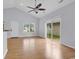 Bright living room with hardwood floors, high ceiling with fan, sliding door access to backyard at 1636 Stuart Square Circle, Myrtle Beach, SC 29577