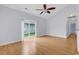 Bright living room with hardwood floors, high ceiling with fan, sliding door access to backyard at 1636 Stuart Square Circle, Myrtle Beach, SC 29577