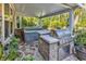 Outdoor kitchen and barbecue area featuring a hot tub and stainless steel grill on a stone patio at 1662 Westminster Dr., Myrtle Beach, SC 29577