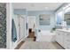 Bathroom featuring a glass shower, soaking tub, and a blue accent wall with natural light at 1662 Westminster Dr., Myrtle Beach, SC 29577