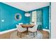 Bright breakfast nook with teal walls, hardwood floors, round table, and seating for four at 1662 Westminster Dr., Myrtle Beach, SC 29577