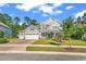 Inviting two-story home with a three-car garage, well-manicured lawn, and charming front porch at 1662 Westminster Dr., Myrtle Beach, SC 29577