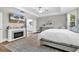 Bright main bedroom with tray ceiling, fireplace, en-suite bathroom, and palm tree view at 1662 Westminster Dr., Myrtle Beach, SC 29577