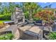 Outdoor patio featuring a stone fireplace, comfortable seating, and attractive landscaping at 1662 Westminster Dr., Myrtle Beach, SC 29577