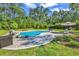 Backyard pool surrounded by green grass, lush landscaping, and lounge chairs at 1662 Westminster Dr., Myrtle Beach, SC 29577