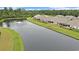 Scenic aerial view of back of homes overlooking a peaceful pond with fountain and green space at 1807 Berkley Village Loop, Myrtle Beach, SC 29579