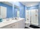 Bright bathroom with a double vanity sink, a framed mirror, and a glass-enclosed shower at 1807 Berkley Village Loop, Myrtle Beach, SC 29579