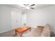 Bright bedroom with carpet, ceiling fan, light walls, closet with double doors, couch, and wooden coffee table at 1807 Berkley Village Loop, Myrtle Beach, SC 29579