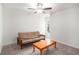 Neutral bedroom boasts natural light with a futon and orange wooden coffee table, creating a cozy space at 1807 Berkley Village Loop, Myrtle Beach, SC 29579