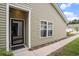 Inviting entrance featuring a stylish black door, complemented by light-colored siding and landscaping at 1807 Berkley Village Loop, Myrtle Beach, SC 29579