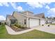 A cozy home with a manicured lawn, featuring a two-car garage and attractive landscaping at 1807 Berkley Village Loop, Myrtle Beach, SC 29579