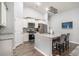 Modern kitchen with stainless steel appliances, white cabinets, granite countertops, and barstool seating at the island at 1807 Berkley Village Loop, Myrtle Beach, SC 29579