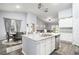 Open kitchen concept with island seating flows to living area with natural light and stainless steel appliances at 1807 Berkley Village Loop, Myrtle Beach, SC 29579