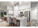Open kitchen featuring stainless steel appliances, an island with seating, and stylish light fixtures at 1807 Berkley Village Loop, Myrtle Beach, SC 29579