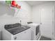 Bright laundry room with modern Whirlpool appliances and white cabinets at 1807 Berkley Village Loop, Myrtle Beach, SC 29579