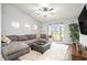 Comfortable living room featuring a plush sectional sofa, entertainment center, and sliding glass doors at 1807 Berkley Village Loop, Myrtle Beach, SC 29579