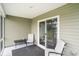 A covered patio features outdoor seating, creating a relaxing extension of the living space at 1807 Berkley Village Loop, Myrtle Beach, SC 29579