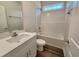 Bathroom featuring white vanity, a shower over tub, and wood-look flooring at 181 Norris Ln, Loris, SC 29569