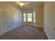 Cozy bedroom with carpeted flooring, a ceiling fan, and a large window for natural light at 181 Norris Ln, Loris, SC 29569