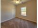 Comfortable bedroom with carpet, closet, and a bright window at 181 Norris Ln, Loris, SC 29569