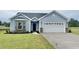 Charming single-story home with blue siding, stone accents, and a well-maintained lawn at 181 Norris Ln, Loris, SC 29569