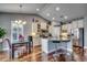 Bright kitchen with an island, bar stools, stainless steel appliances, and a chandelier over the dining area at 1903 Francis Ct., Myrtle Beach, SC 29577