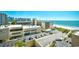 Beach view of the condo community showing nearby hotel, parking and ocean at 201 74Th Ave. N # 707, Myrtle Beach, SC 29572