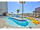 Resort-style lazy river with lounge chairs, palm trees, and a shallow depth perfect for relaxation at 201 74Th Ave. N # 707, Myrtle Beach, SC 29572