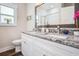 Bright bathroom featuring white cabinets, granite countertops, and double vanity sinks at 2080 Highway 915, Loris, SC 29569