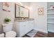 This bathroom features white cabinets with a granite countertop and double vanity sinks at 2080 Highway 915, Loris, SC 29569