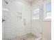 Newly remodeled glass enclosed shower boasts beautiful tile work and an inset shelf for storage at 2080 Highway 915, Loris, SC 29569