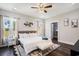 Bright bedroom featuring a ceiling fan, a large bed with stylish rug, and a walk-in closet at 2080 Highway 915, Loris, SC 29569