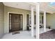Inviting front porch with seating area and decorative front door at 2080 Highway 915, Loris, SC 29569