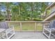 Private outdoor deck features comfortable seating and wooded backyard view at 213 Westleton Dr. # 16-D, Myrtle Beach, SC 29572