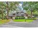 Charming condo featuring a well-maintained exterior with lush landscaping and mature trees providing shade and curb appeal at 213 Westleton Dr. # 16-D, Myrtle Beach, SC 29572