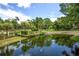 A serene pond reflecting the surrounding trees and blue sky adds to the natural beauty of this idyllic community at 213 Westleton Dr. # 16-D, Myrtle Beach, SC 29572
