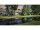Beautiful backyard with a pond reflecting the exterior of the condos surrounded by trees at 2150 Longwood Lakes Dr. # 2150, Myrtle Beach, SC 29579