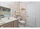 Bathroom with floral wallpaper, classic fixtures, and ample storage at 2150 Longwood Lakes Dr. # 2150, Myrtle Beach, SC 29579