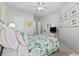 Light bedroom with a floral comforter set and bright walls with access to an ensuite at 2150 Longwood Lakes Dr. # 2150, Myrtle Beach, SC 29579