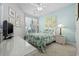 Cozy bedroom with floral bedding, a ceiling fan, and ample natural light from the window at 2150 Longwood Lakes Dr. # 2150, Myrtle Beach, SC 29579