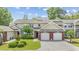 Charming exterior view of townhome showcasing manicured lawn, brick accents, and a two-car garage at 2150 Longwood Lakes Dr. # 2150, Myrtle Beach, SC 29579