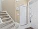 Welcoming foyer featuring a staircase, front door with decorative glass, and neutral color palette at 2150 Longwood Lakes Dr. # 2150, Myrtle Beach, SC 29579