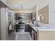 Modern kitchen with stainless steel appliances, dark wood cabinets, and breakfast bar at 2150 Longwood Lakes Dr. # 2150, Myrtle Beach, SC 29579
