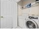 Bright laundry room featuring a side-by-side washer and dryer and storage shelves at 2150 Longwood Lakes Dr. # 2150, Myrtle Beach, SC 29579