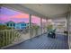 Charming balcony showing seating and view of nearby buildings at dusk at 22 Ocean Blvd. N, Surfside Beach, SC 29575