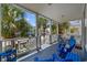 Comfortable porch offers seating and a view of palm trees and neighborhood at 22 Ocean Blvd. N, Surfside Beach, SC 29575
